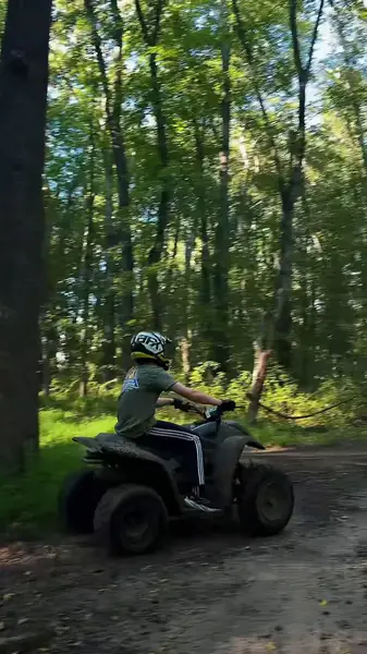 ATV riders on a tree-lined trail at NJ ATV Rentals