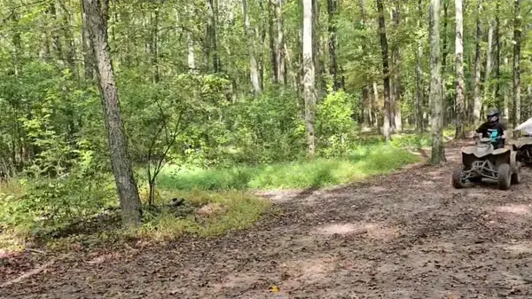 Quad riders cruising a sandy trail at NJ ATV Rentals