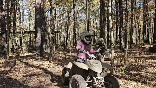 ATV riders on a tree-lined trail at NJ ATV Rentals